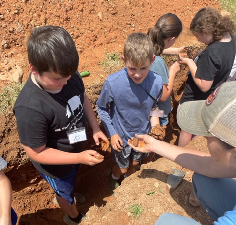 Examining soil at Rohrbachs Ag Camp