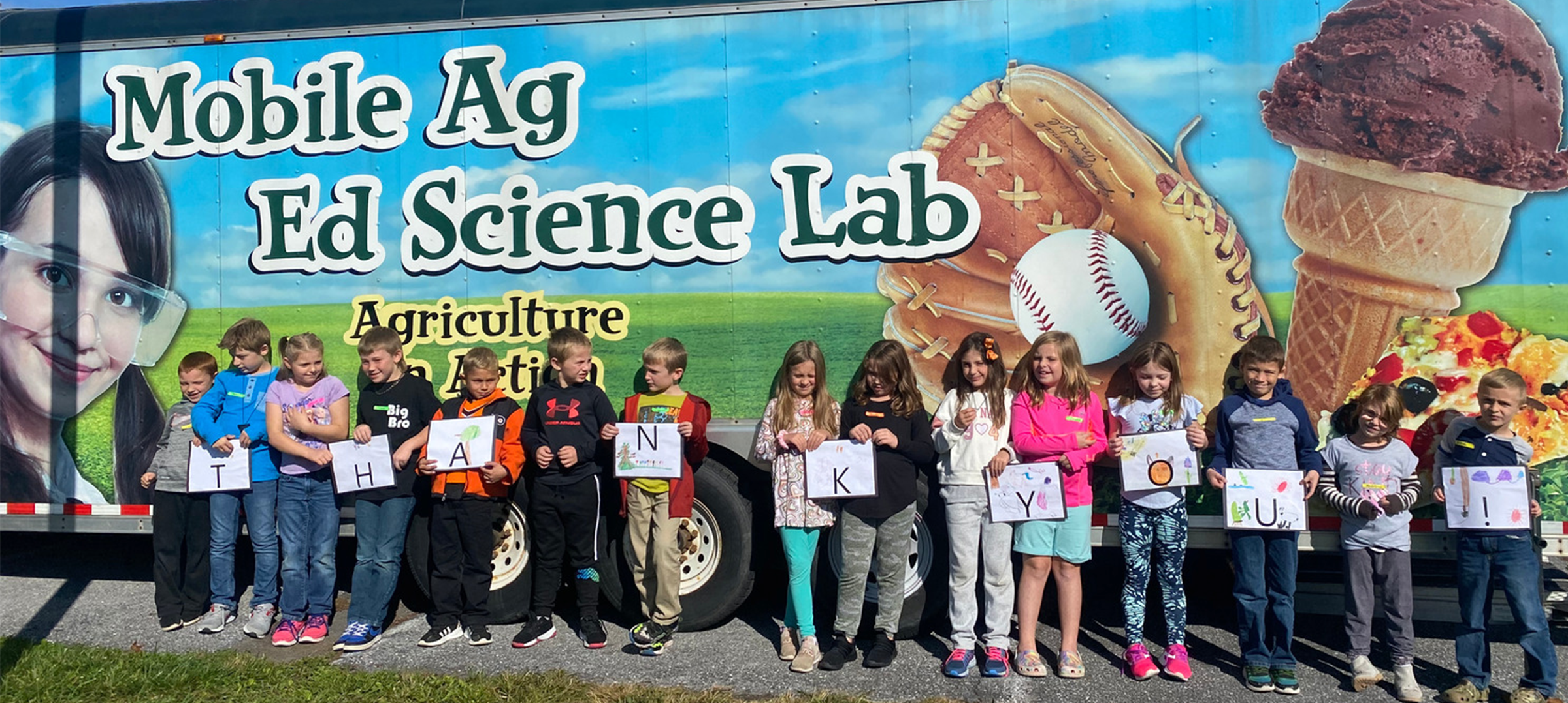 Students stand in front of the Mobile Ag Ed Science Lab